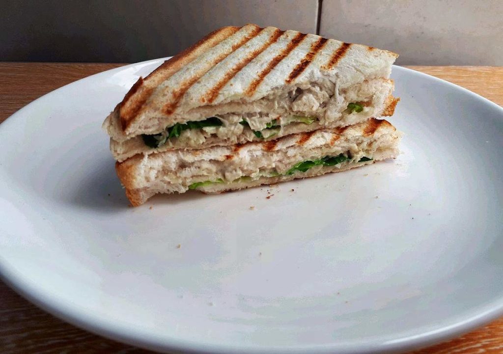 A Filipino style chicken sandwich spread served on a plate
