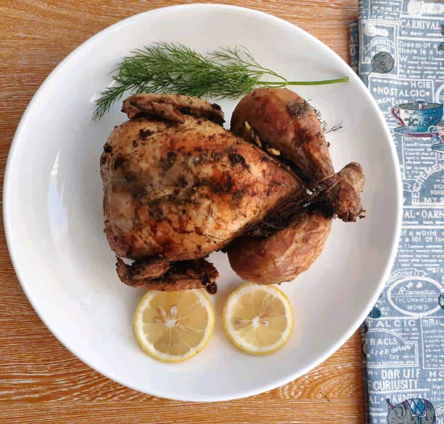 Roasted herb chicken recipe serve with slices of lemon