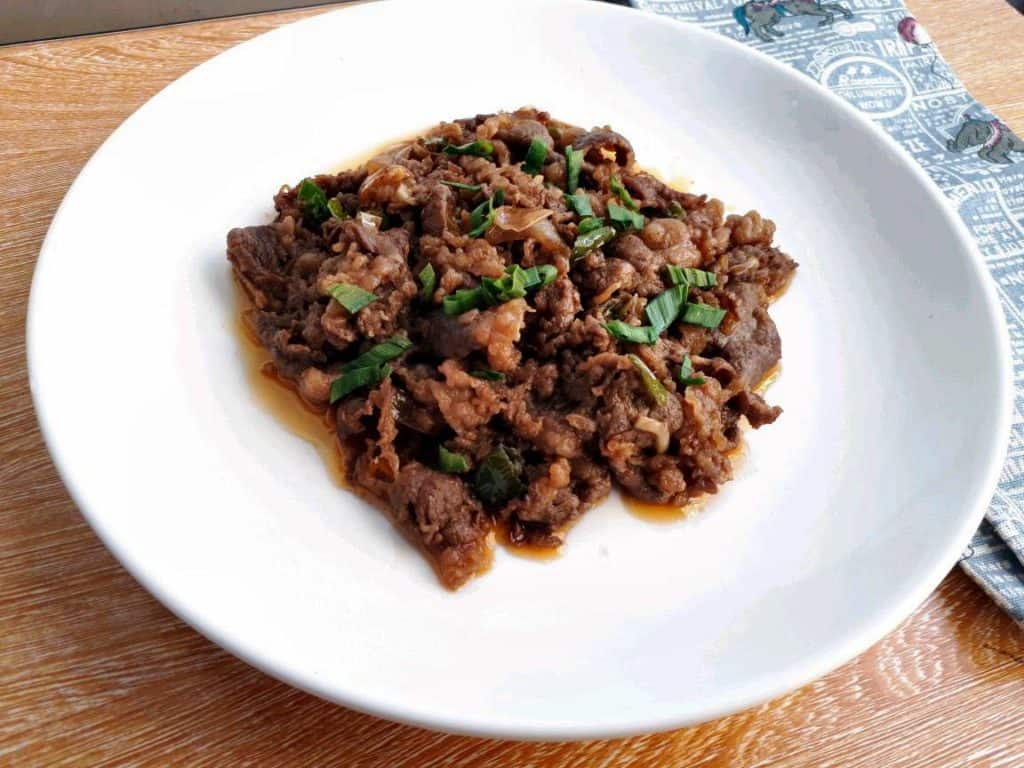 Spicy Korean Beef Stir Fry garnish with leaves of spring onion