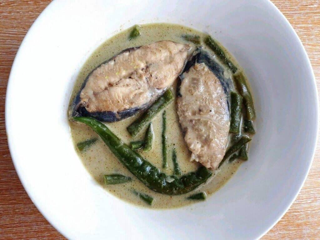Thai Fish Green Curry with green beans and chilies in a bowl.
