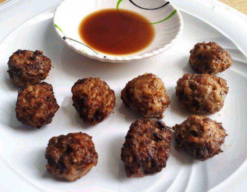 Beef Bola Bola meatball served with soy vinegar sauce in a plate