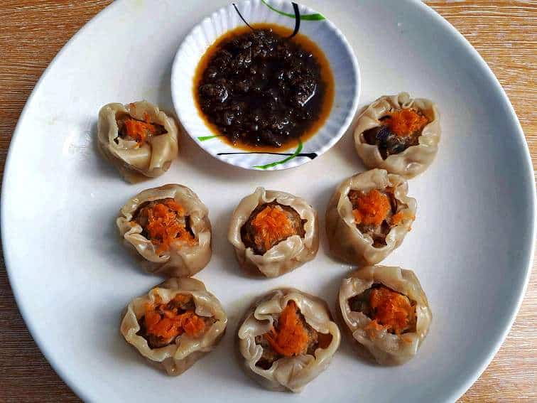 Beef Siomai Recipe garnished with grated carrots and serve with chili garlic oil.