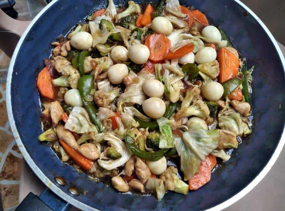A Filipino Chop suey mixed with chopped chicken, carrot, cauliflower, broccoli, quail egg and cabbage serve in a pan