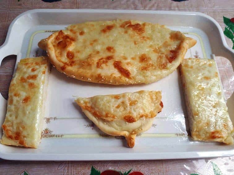 Turkish cheese flatbread called Cheese pide which is topped with Mozzarella and Cheddar Cheese