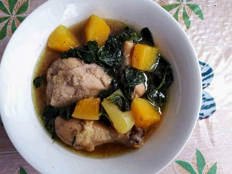 Chicken Papaya Recipe mixed with unriped papaya, chicken, spinach and with seasoned broth served on a plate bowl.