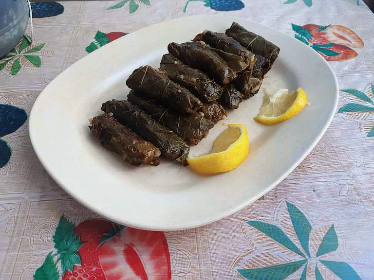 Lebanese Stuffed Grape Leaves Warak Enab with slices of Lemon