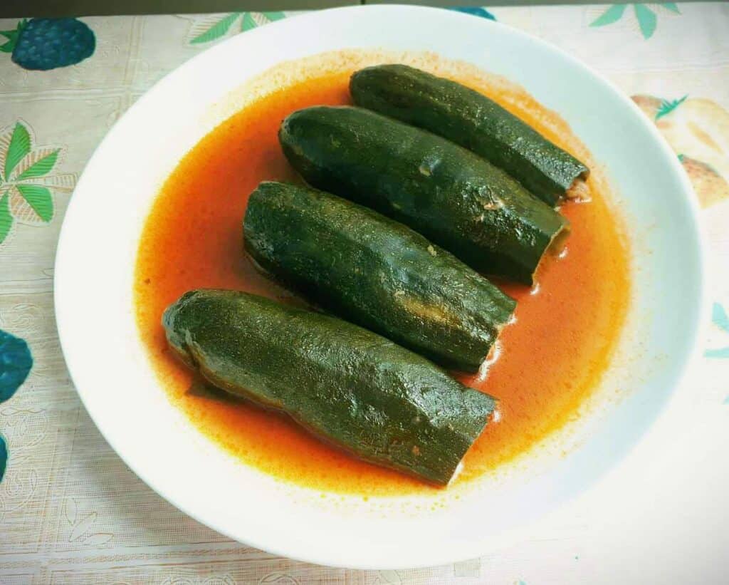 A Lebanese stuffed Zucchini called Kousa Mahshi served with tomato broth on a plate