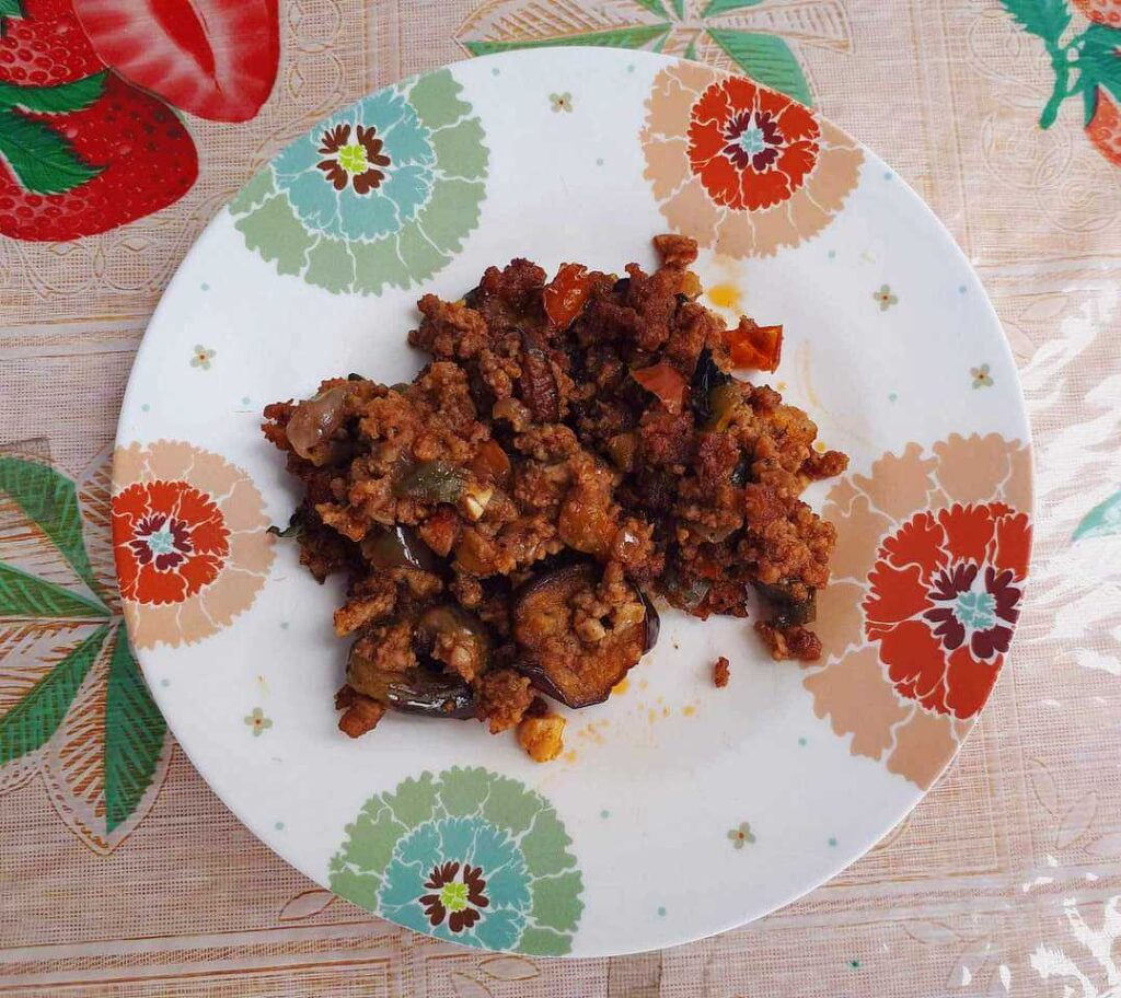 A Turkish moussaka dish mixed with ground beef, tomato sauce, and eggplant serve on a plate