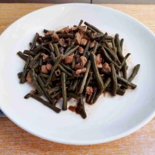 Adobong Sitaw green bean recipe mixed with chopped boneless chicken breast on a plate