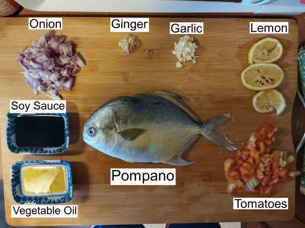 Recipe ingredients of Whole Baked Pompano that contain soy sauce, tomatoes. red onion, ginger and garlic