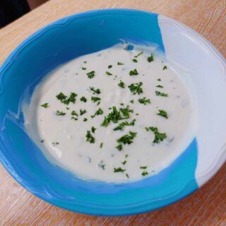 Yogurt Garlic sauce sprinkled with chopped parsley on a plate bowl best for Shawarma, Kebab or Salad dressing