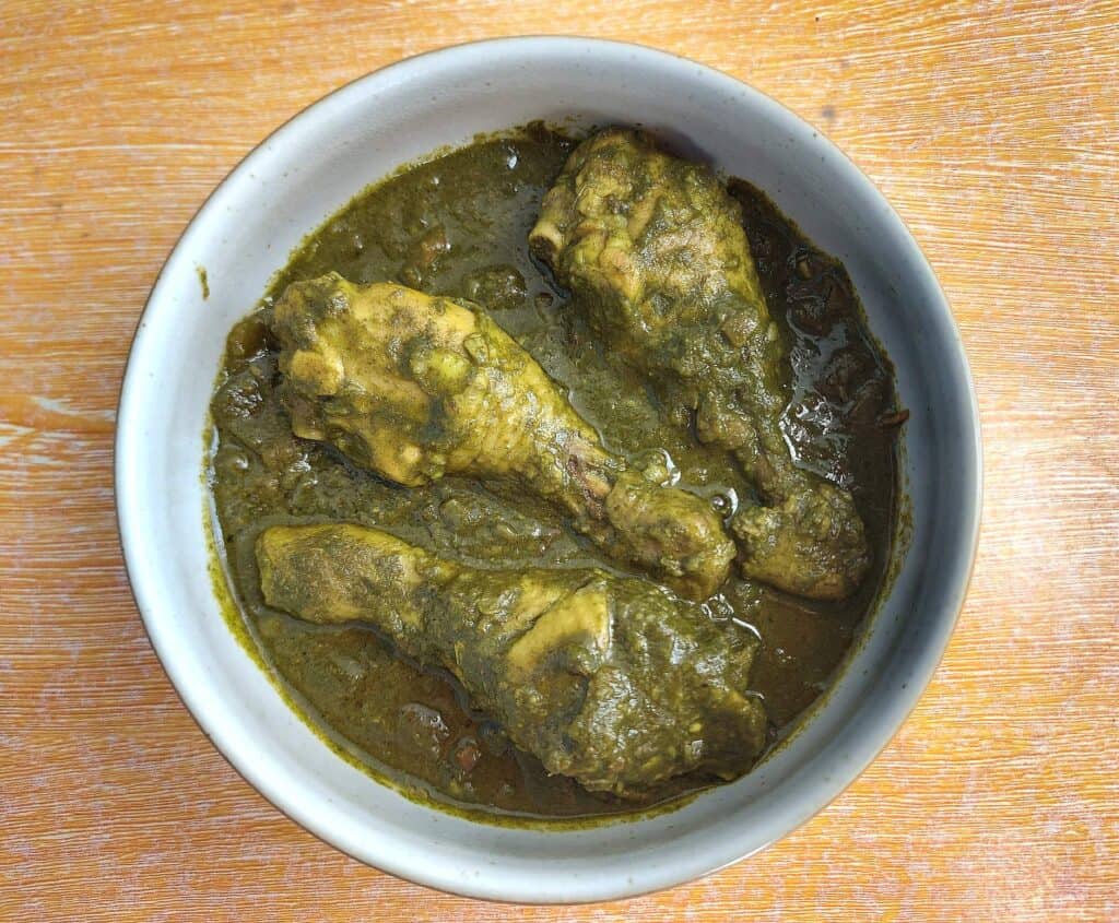 Indian Spinach Chicken Curry Palak Chicken drumstick serve on a plate