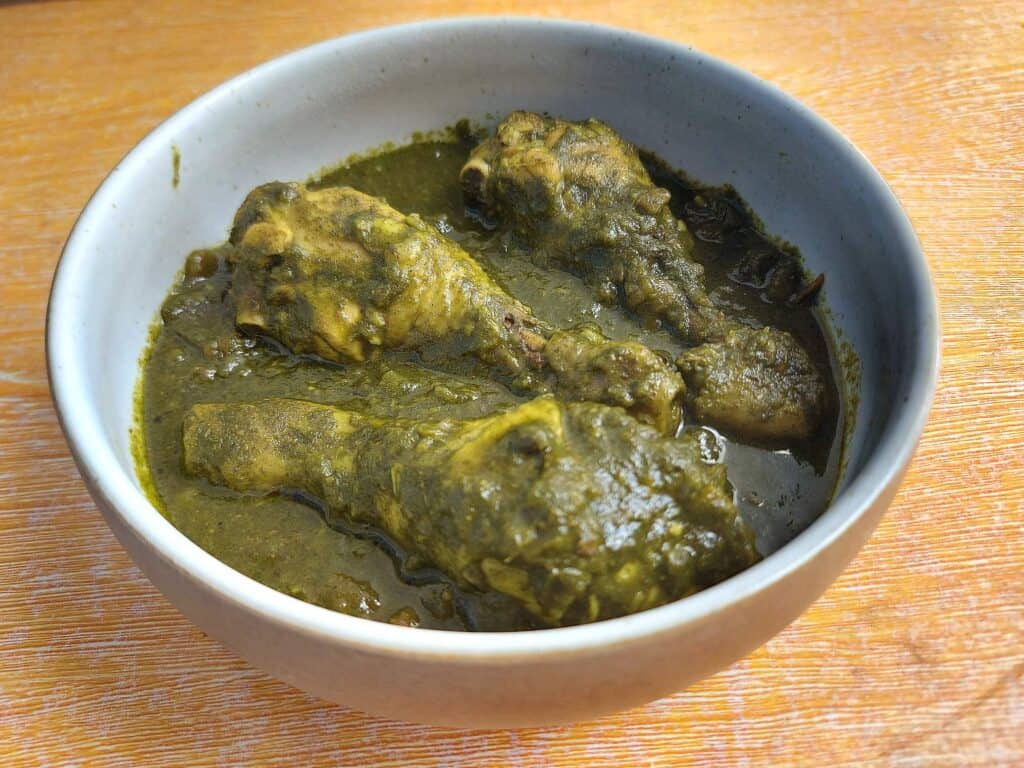 Indian Spinach Chicken Curry Palak Chicken drumstick serve on a plate