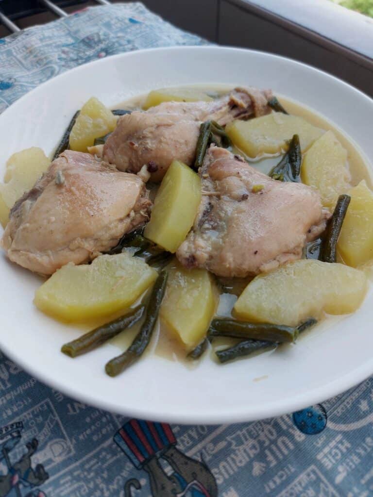 Filipino chicken coconut milk stew Ginataang Manok with Papaya and Green beans served on a plate