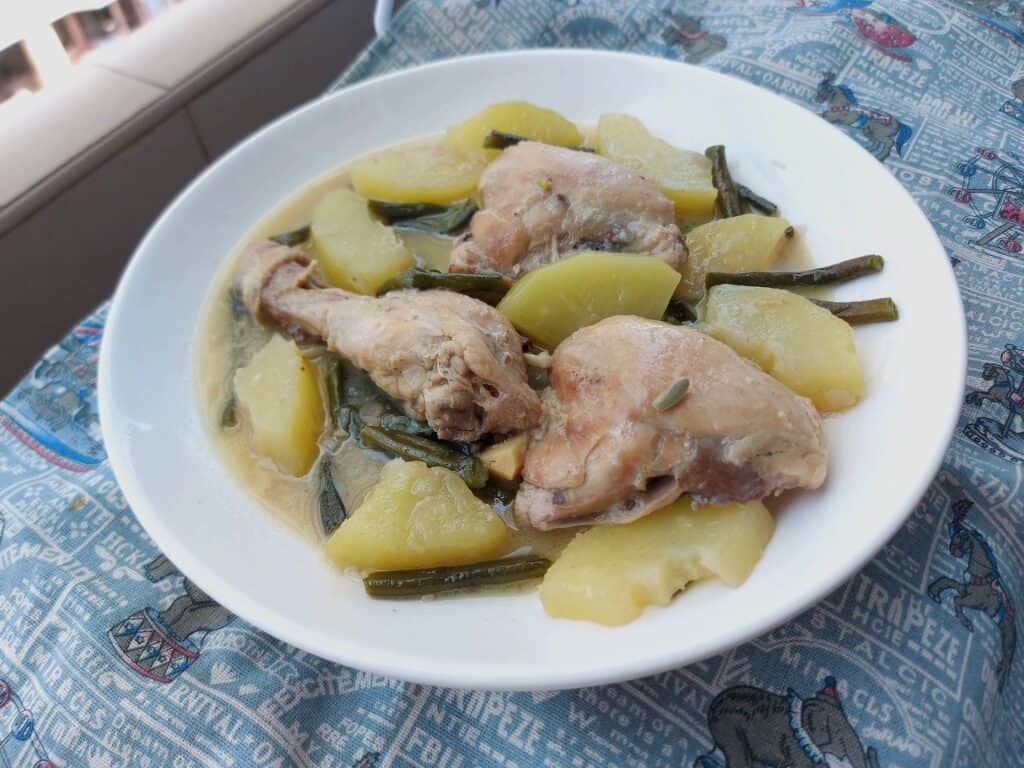 Filipino chicken coconut milk stew Ginataang Manok with Papaya and Green beans served on a plate