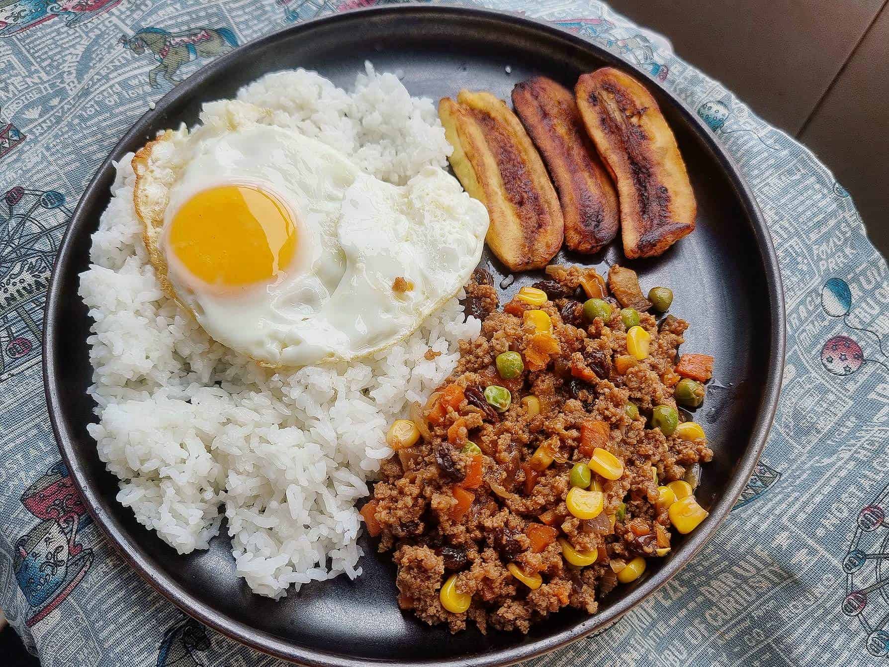 Filipino Arroz Ala Cubana recipe mixed with ground beef, fried plantain and white rice topped with sunny-side up egg