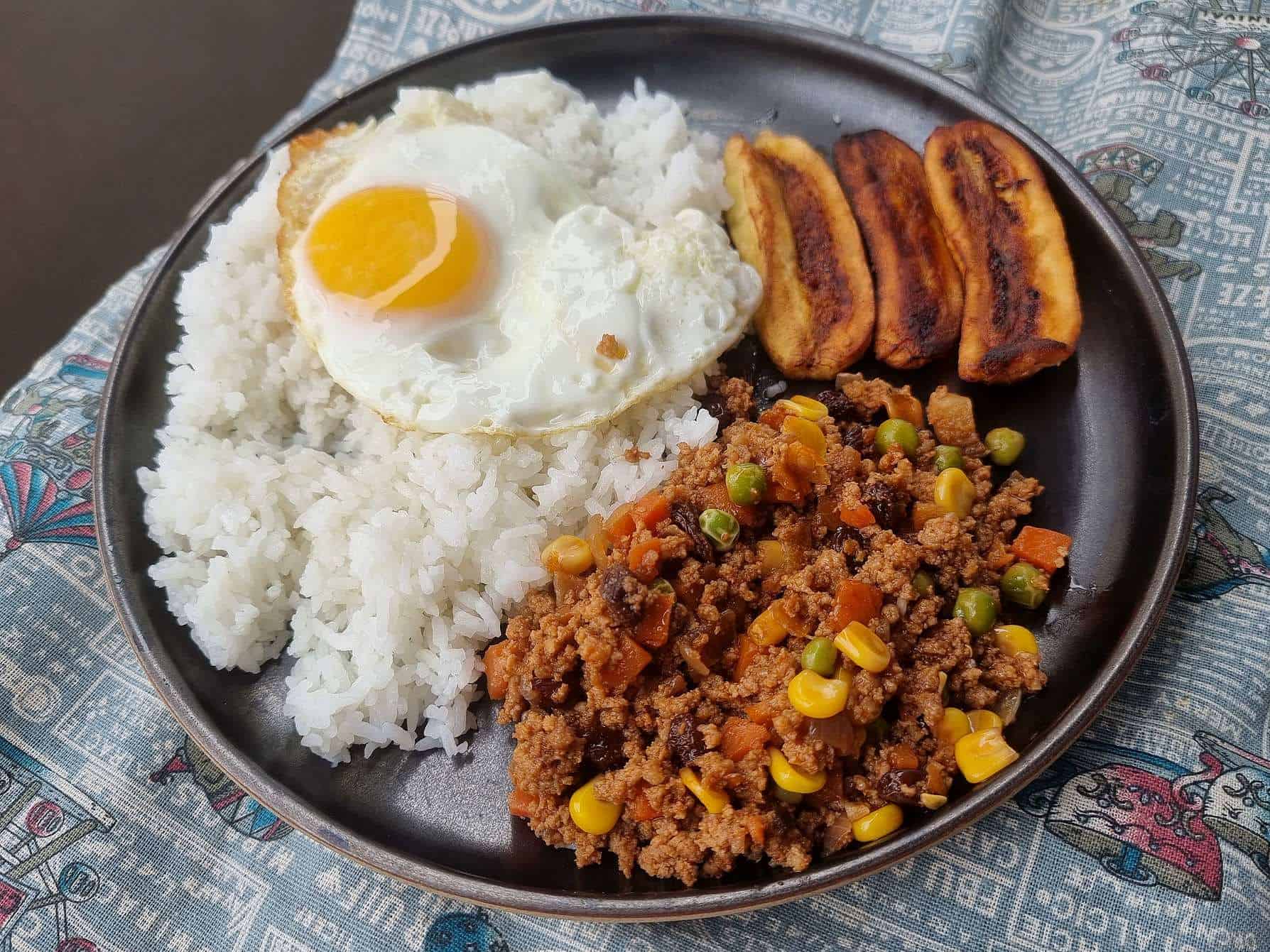 Filipino Arroz Ala Cubana recipe mixed with ground beef, fried plantain and white rice topped with sunny-side up egg