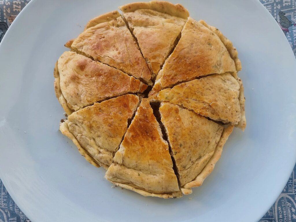 Moroccan Berber pizza medfouna with ground meat filling served in a plate.