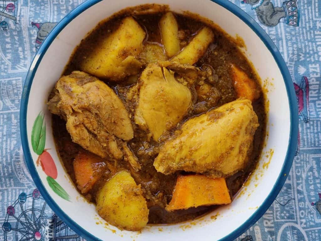 Somali chicken stew Maraq Digaag served with potatoes & carrots in a plate bowl