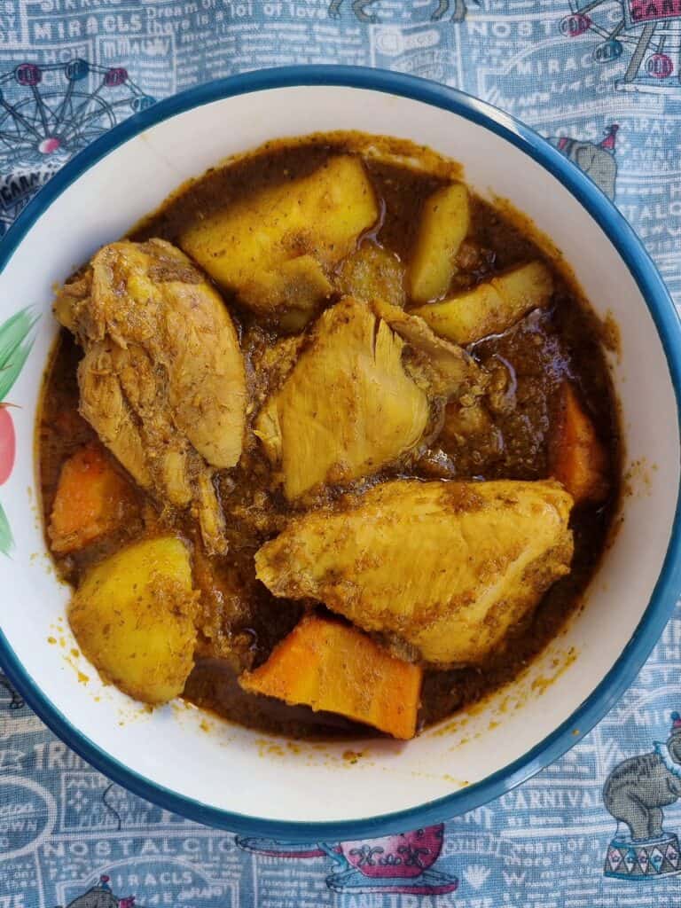 Somali chicken stew Maraq Digaag served with potatoes & carrots in a plate bowl