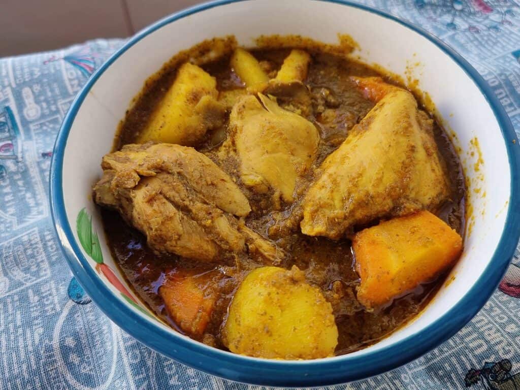 Somali chicken stew Maraq Digaag served with potatoes & carrots in a plate bowl