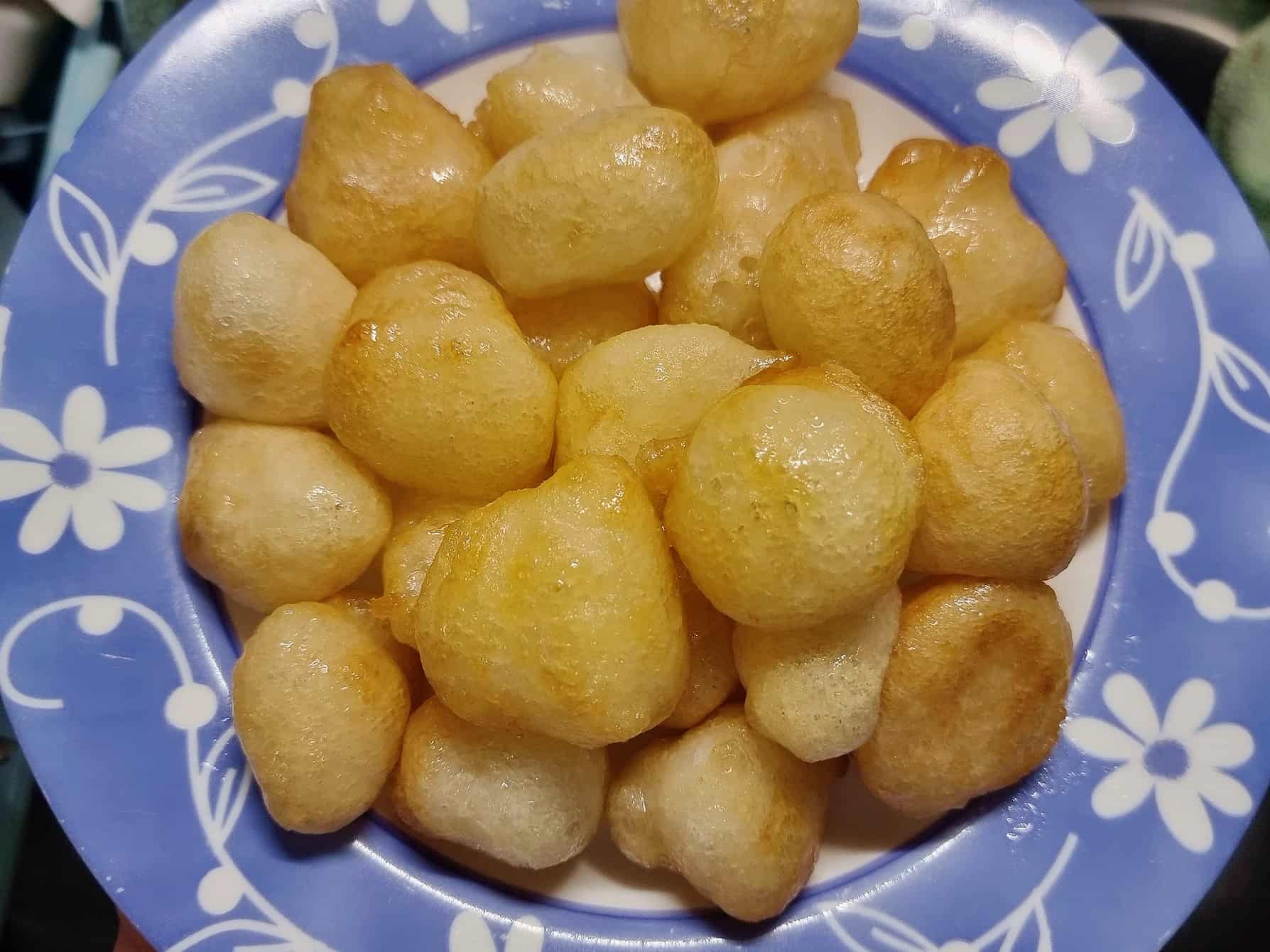 Middle Eastern fried doughnut ball Awama / Awameh coated with syrup serve in a plate.