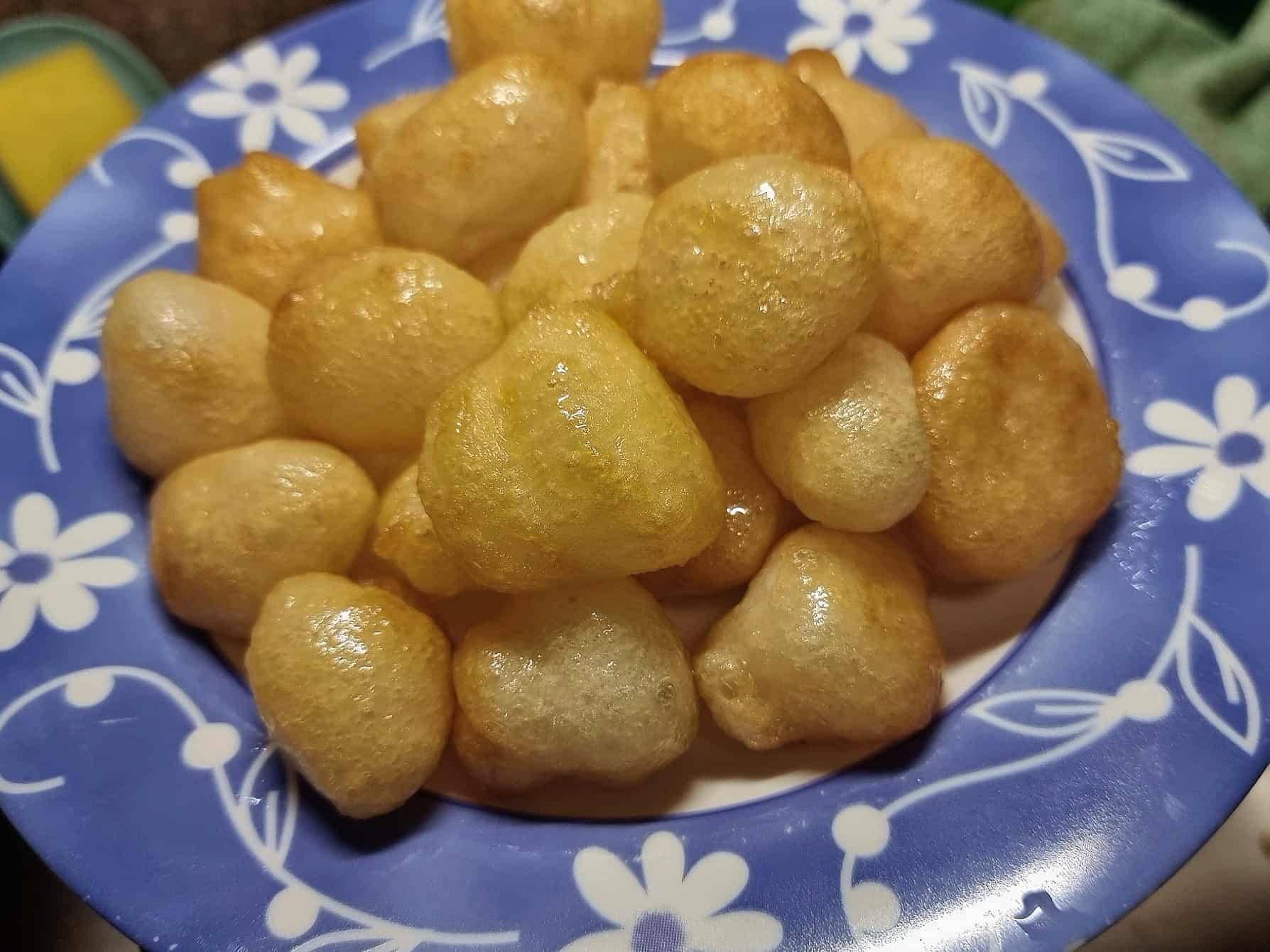 Middle Eastern fried doughnut ball Awama / Awameh coated with syrup serve in a plate.