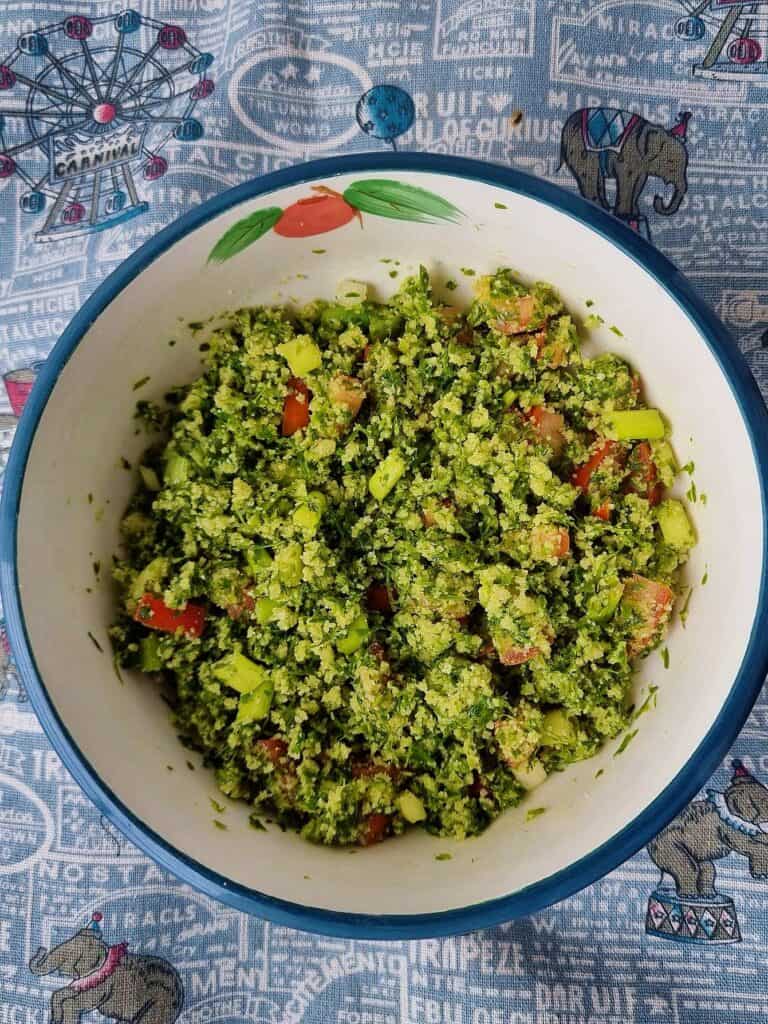 A colorful Moroccan Tabbouleh Salad, a vegetarian dish featuring couscous, tomatoes, parsley, and spring onion, seasoned with lemon juice and olive oil.