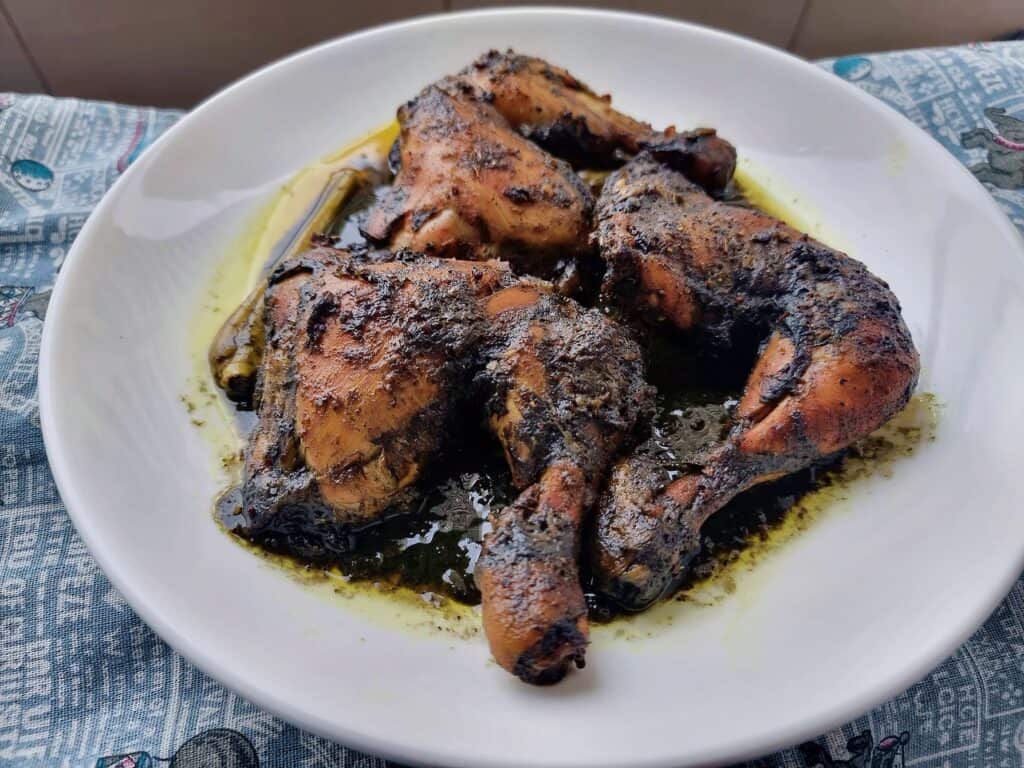 A Filipino Burnt coconut chicken Piyanggang Manok served on a plate.