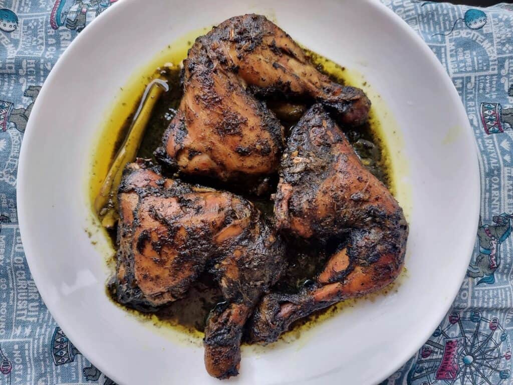 A Filipino Burnt coconut chicken Piyanggang Manok served on a plate.