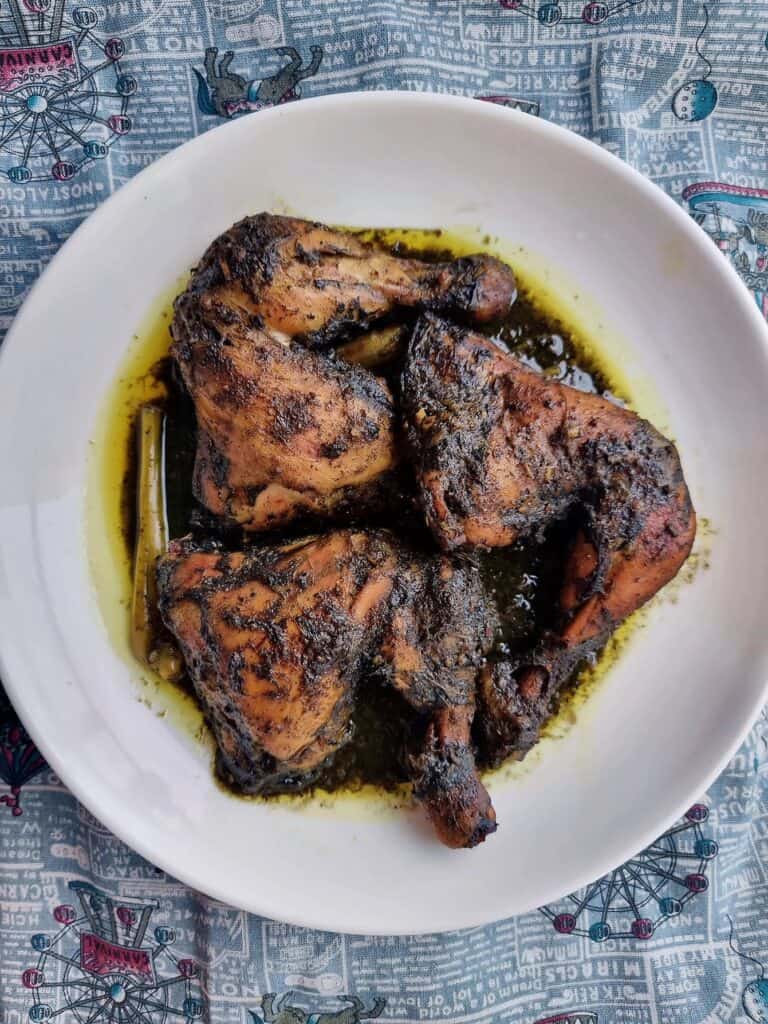 A Filipino Burnt coconut chicken Piyanggang Manok served on a plate.