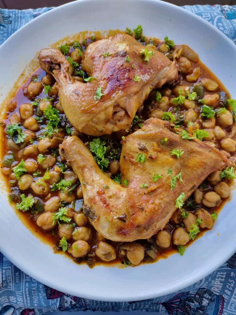 Algerian dish Chtitha Djedj with chicken leg quarters & chickpeas garnished with chopped parsley